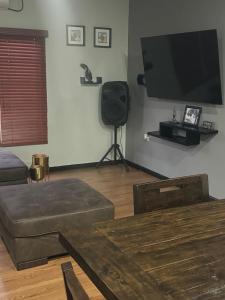 a living room with a flat screen tv on the wall at Casa No6 Ascot in Carapo
