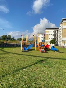 a park with a playground with colorful play equipment at De' Haven Stay - 10minutes to Airport Tawau in Tawau