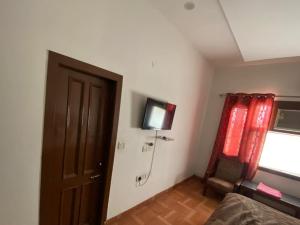 a room with a shower and a door and a window at Fab Krishna hotal in Panchkula