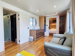 a living room with a couch and a bedroom at Udo Chano Village in Jeju