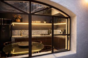 a dining room with a table and a kitchen at Casa UMA in San Miguel de Allende