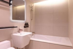a bathroom with a tub and a sink and a toilet at Seocho JS Hotel in Seoul +36 photos