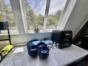 a table with glasses and a toaster and a window at A Frame house Perú in Lambayeque