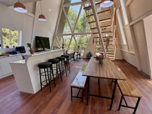 a room with a bar and a counter with stools at A Frame house Perú in Lambayeque