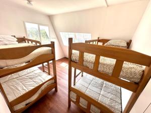 a room with three bunk beds in it at A Frame house Perú in Lambayeque +85 photos