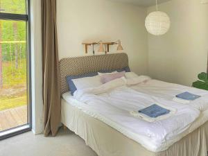 a bed in a room with a large window at Architect Villa By Cliff Bathing In High Coast in Härnösand +16 photos
