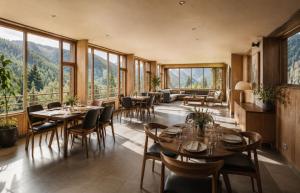 a dining room with tables and chairs and windows at Hotel Grand Kings Premium in New Delhi