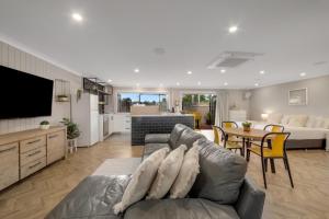a living room with a couch and a table at Raintree Motel Biloela in Biloela