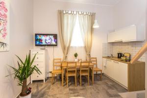 a kitchen and dining room with a table and chairs at Inga Vacation House in Druskininkai