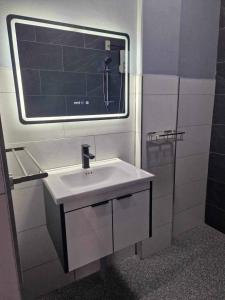 a bathroom with a sink and a mirror at S & R Homes in Tacloban +8 photos