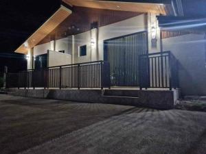 a building with a fence on the side of it at night at S & R Homes in Tacloban