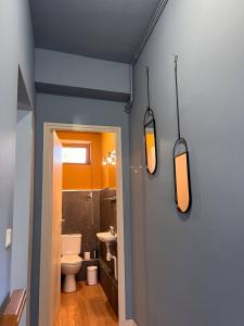 a bathroom with a toilet and two lights on the wall at 32-La Place To Be in Senlis +23 photos