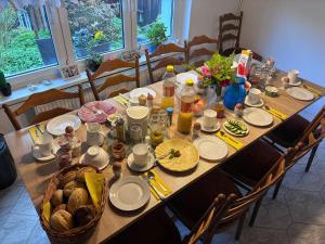a table with food and a basket of food on it at Haus Bergfriede in Bad Schandau