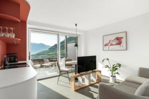 a living room with a couch and a television at Ferienwohnungen Steinegg in Lagundo