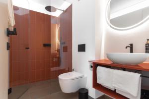 a bathroom with a sink and a toilet and a shower at Ferienwohnungen Steinegg in Lagundo +16 photos