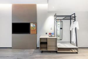 a bathroom with a sink and a mirror at Wanda Moments Nanchang in Xinjian +13 photos