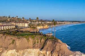 a building on a cliff next to the ocean at Pacific Point Resort in Pismo Beach