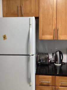 a kitchen with a white refrigerator and a toaster at 温哥华列治文别墅民宿33 in Richmond