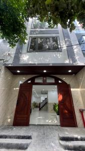 an entrance to a building with two large wooden doors at Han House's Apartment in Danang