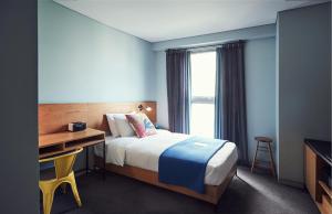 a bedroom with a bed and a desk and a window at La Casa Hotel Seoul in Seoul +90 photos