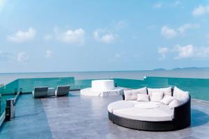a living room with a white couch and the ocean at Sky Beach Pool Villa Chanthaburi 2 in Laem Sing +37 photos