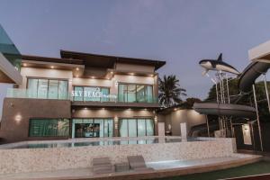 a house with a swimming pool in front of it at Sky Beach Pool Villa Chanthaburi 2 in Laem Sing
