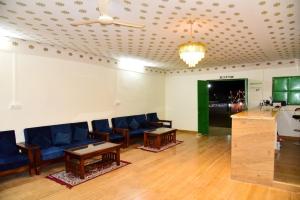 a living room with blue couches and a table at Big Brand Desert Camp in Jaisalmer