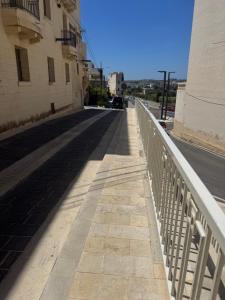 an empty street with a white railing on a road at rabat apartment in Rabat