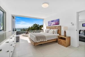 a bedroom with a bed and a view of the ocean at Picture Point Terraces in Noosa Heads +133 photos