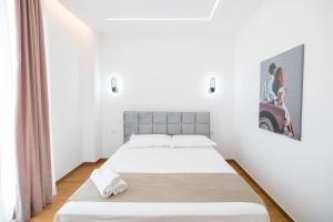 a bedroom with two beds and a picture of a motorcycle on the wall at Riverside Villa in Tragjas