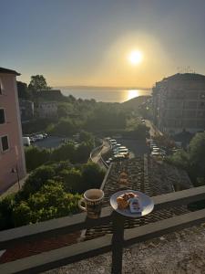 a table with a plate of food and a cup of coffee at Casa Silvia in Bracciano