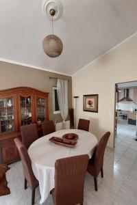 a dining room with a white table and chairs at Villa Alexandra Rio Patra in Áyios Vasílios +29 photos