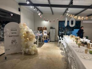 a group of tables with white balloons on them at מטע וכרם in Elqosh +31 photos
