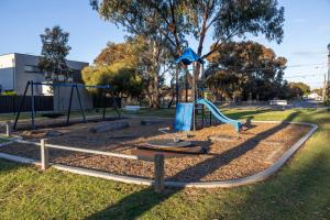 a playground with a slide in a park at Belle Escapes Henley's Coastal Charm in Henley Beach South