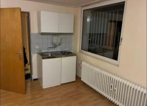 a small kitchen with a sink and a window at Apartments an der Messe in Düsseldorf