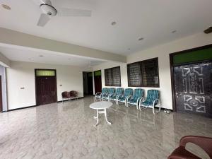 a room with chairs and a table and a door at Hotel Comfort Hill in Abbottabad