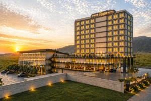 a rendering of a hotel with a sunset in the background at Prime Plaza Hotel Mataram in Mataram