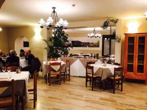 a restaurant with tables and people sitting at tables at Hotel Ristorante La Grotta in Castiglione delle Stiviere