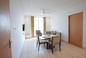 a kitchen and dining room with a table and chairs at Annekaa Heights in Vrindāvan