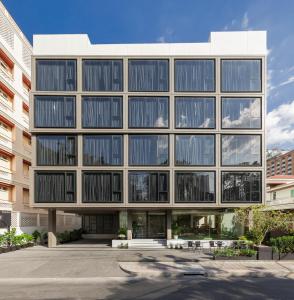 an office building with a lot of windows at Volve Hotel Bangkok in Bangkok