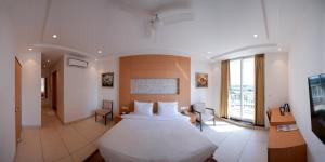 a bedroom with a large bed in a room at Annekaa Heights in Vrindāvan