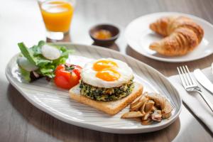 a plate of food with an egg on top of toast at Volve Hotel Bangkok in Bangkok