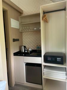 a small kitchen with a stove and a microwave at The Playground in Baras