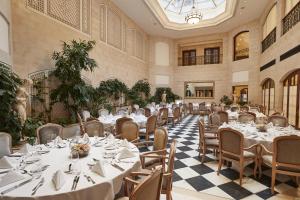 a banquet hall with white tables and chairs at Hotel Adlon Kempinski Berlin in Berlin