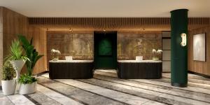 a lobby with two sinks and a green door at Hyatt Regency London Olympia in London