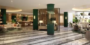 a lobby with green columns in a building at Hyatt Regency London Olympia in London