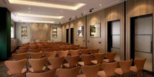 a lecture hall with rows of chairs in it at Hyatt Regency London Olympia in London +52 photos
