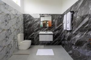 a bathroom with a toilet and a sink at Mashmellow Resort and Spa in Galle +90 photos