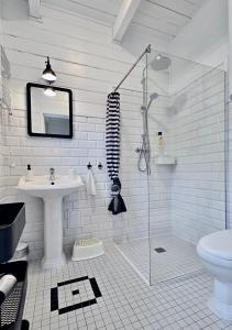 a white bathroom with a sink and a shower at Bla Marine Domki nad Morzem in Grzybowo +68 photos