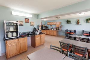 a room with a kitchen with a table and chairs at Super 8 by Wyndham Elkhart in Elkhart